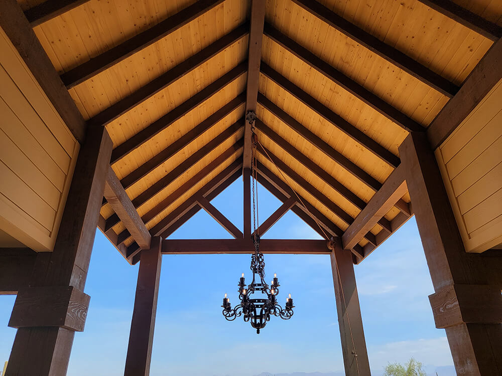 Log beam custom entrance with chandlier. Custom home built by Resurrection Builders of Gilbert AZ.
